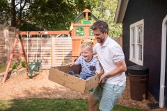 Father flies son in a cardboard spaceship during Grand Rapids family day in the life session