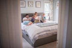 East Grand Rapids family cuddles and reads books at bed time during a family photography session