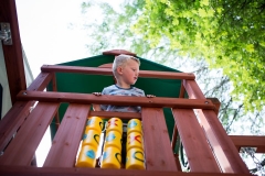 Boy plays in fort during day East Grand Rapids in the life family documentary picture session