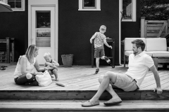 Family of four relax on their deck while a Grand Rapids documentary photographer photographs them