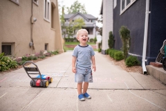 Child laughs joyously as a Grand Rapids family documentary photographer captures his portrait