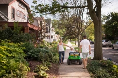 Grand Rapids documentary family photographer image of a family walking through sunny East Grand Rapids neighborhoods