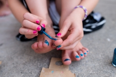 Close up documentary photography session image of young Grand Rapids girl painting her toenails