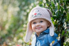 Child portrait of a toddler in a cute knit hat