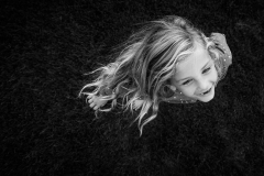 Flowing hair and strinking black and white characterize this artistic child portrait