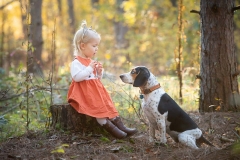 Child and dog portrait in a fall Michigan natural forest