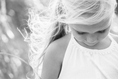 Sunlight and wind combine to create an artistic black and white child portrait