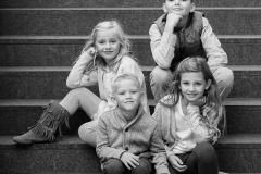 Four siblings pose for family portraits in downtown Grand Rapids