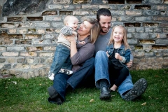 A West Michigan family laughs together in a downtown Grand Rapids family photograph