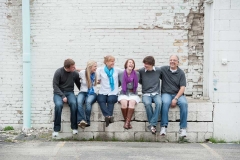 Grown children laugh with their parents in this downtown Grand Rapids lifestyle portrait