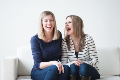 Sisters share a moment of candid laughter in this Grand Rapids family portrait