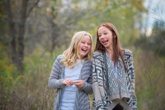 Tween girls laugh together in a candid lifestyle family portrait