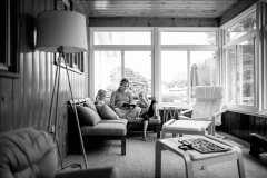 Mom and three girls read in a documentary family portrait session