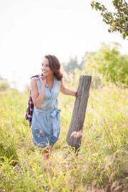 Laughing girl senior photo in a field near Grand Rapids