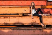 Urban Grand Rapids senior picture of girl on orange steel beams