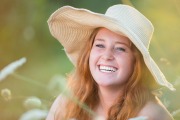 A sunhat complements a natural fall field setting for Grand Rapids senior portrait photography