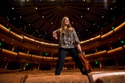 Creative senior picture of a girl with a violin in a Grand Rapids auditorium