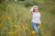 Senior girl poses for portraits in field of flowers Grand Rapids Millennium Park