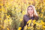 Grand Rapids senior portrait photographer captured a young woman posing among yellow flowers