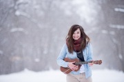 Grand Rapids senior portrait of a girl playing a ukelele in a Michigan winter senior portrait