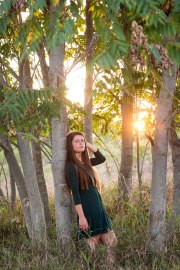 Girl poses for a Michigan sunset senior portrait near Grand Rapids