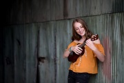 Girl plays a ukelele in a Grand Rapids senior portrait