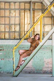 Young woman poses on stairs for Grand Rapids high school senior portraits