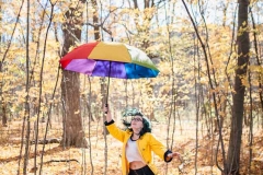 Creative and artistic senior portrait of a girl in fall Grand Rapids area woods