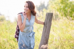 Laughing girl senior photo in a field near Grand Rapids