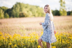 Grand Rapids senior laughs brightly in a fall Michigan field