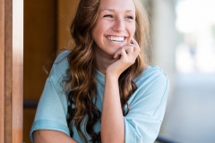 Girl laughs in her senior picture by a Grand Rapids senior picture photographer