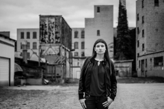 A senior girl poses dramatically in this urban Grand Rapids senior portrait