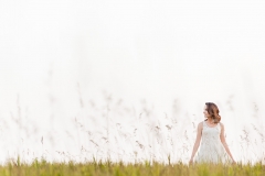 Senior photos of a girl in a summer field near Grand Rapids