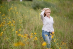 Senior girl poses for portraits in field of flowers Grand Rapids Millennium Park