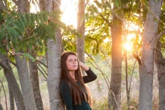 Girl poses for a Michigan sunset senior portrait near Grand Rapids