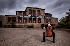 Urban Grand Rapids senior portrait of a boy playing the cello