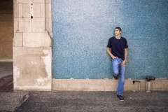 Senior boy poses for urban Grand Rapids senior portrait photography