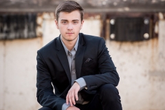 Well dressed guy poses for male high school senior portraits in downtown Grand Rapids