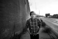 Senior guy walks in downtown Grand Rapids for high school senior portraits