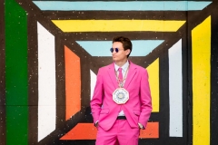 Senior boy dressed in a pink suit for his Grand Rapids senior pictures
