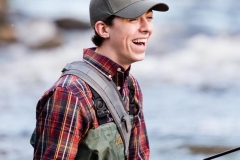 Fly fisherman guy poses for male senior portraits in Grand Rapids