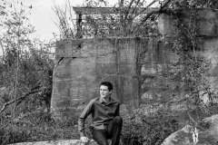 Senior boy poses in gritty natural setting near Grand Rapids for male senior portraits