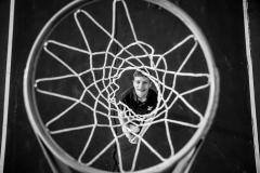 Basketball athlete poses for creative portrait by Grand Rapids senior pictures photographer