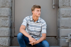 Senior guy casually poses for senior pictures in Grand Rapids
