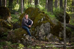 Senior guy poses for male senior pictures in a natural Michigan setting