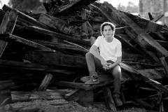 Grandville high school senior guy poses on discarded railroad ties near downtown Grand Rapids