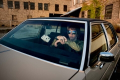 Grandville high school senior poses with his car near down town Grand Rapids for male senior portraits