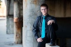 Senior guy poses in urban Grand Rapids for male senior portraits