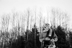 Snowboarder guy poses for male senior portraits at Cannonsburg Ski Area during a Grand Rapids winter