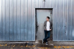 Guy poses for senior portraits in downtown Grand Rapids